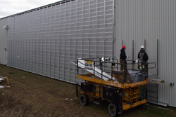 RTSI personnel install Lubi solar collectors on the Plastech facility in Sherbro